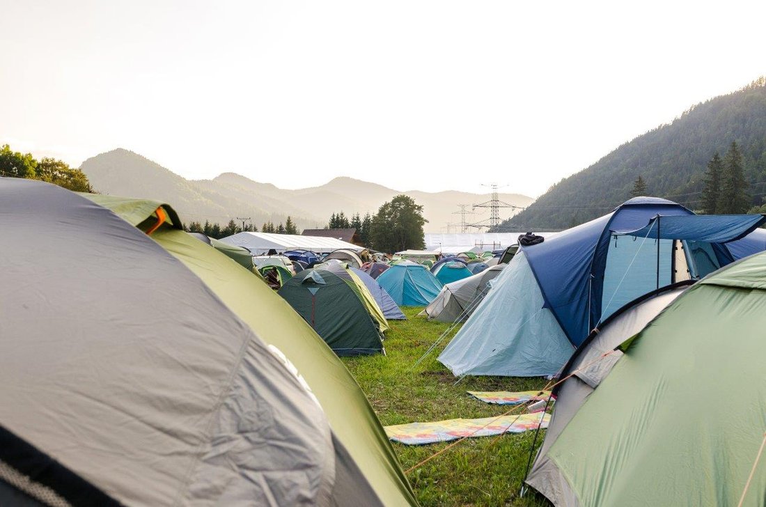 camping-travel-holidays.jpg Tents set up on a campground in a mountainous region.